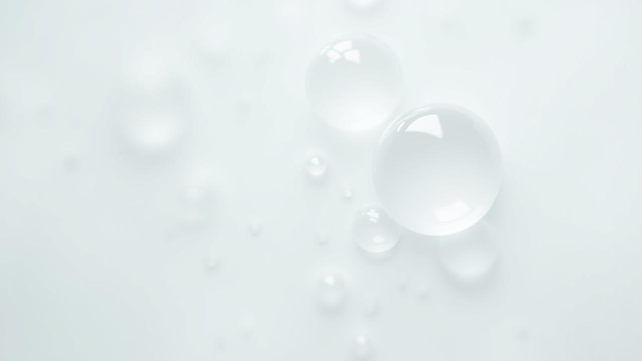 Macro shot of gentle soap bubbles on a pristine white surface, highlighting purity and freshness.